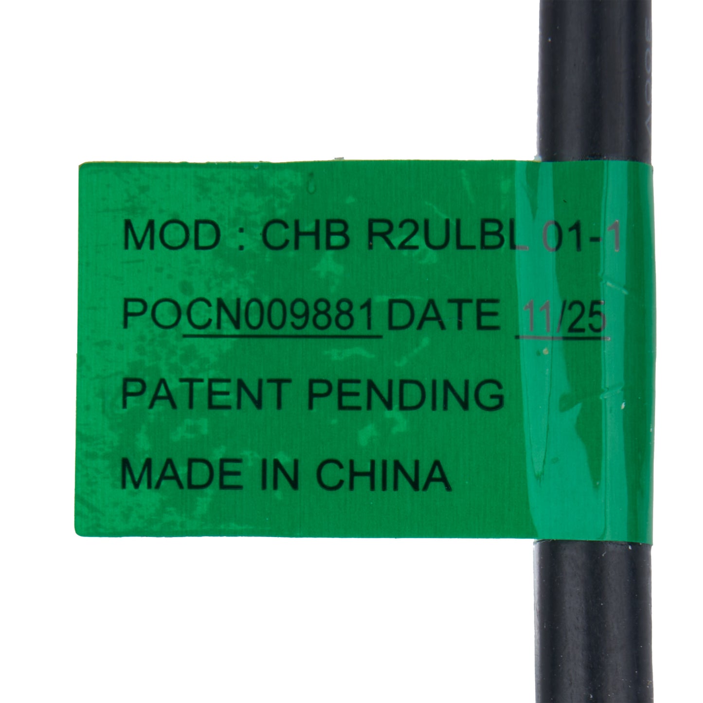 Green label with text on a black cylindrical object