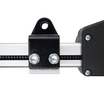 Close-up of a black metal linear rail bracket with two silver screws, attached to a silver aluminum rail, with a black end housing on the right, isolated on a white background.