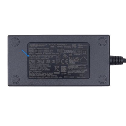 Black power adapter with certification labels on a white background