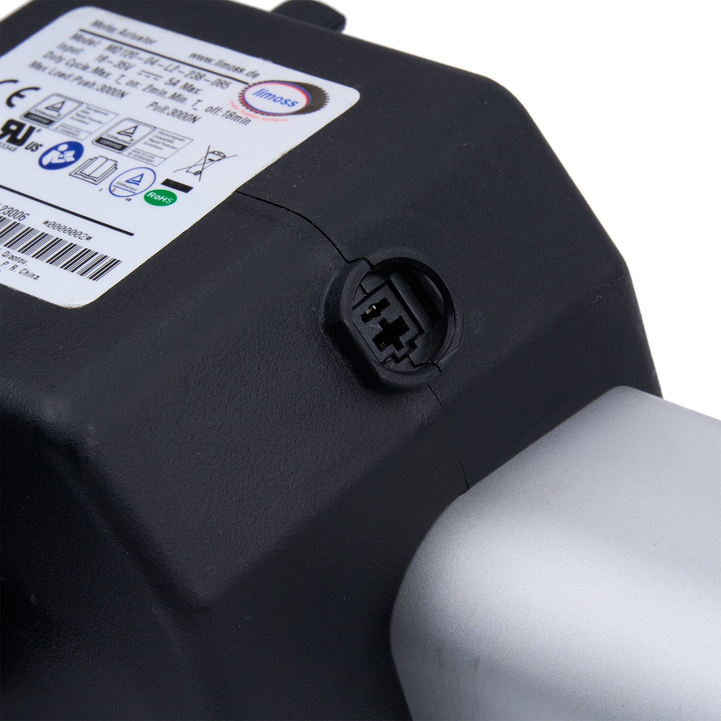 Close-up of a black battery pack with a label and connector on a white background