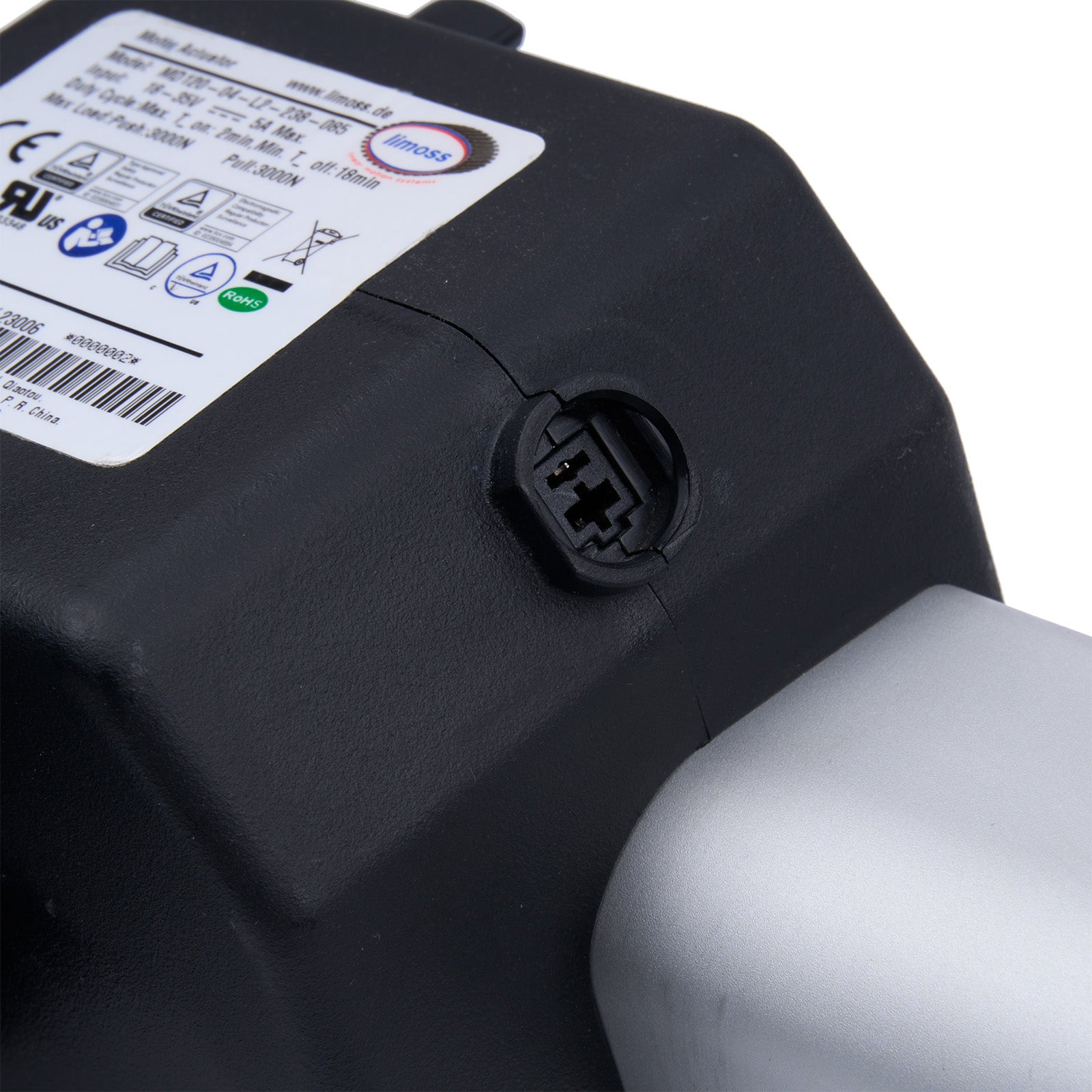 Close-up of a black battery pack with a label and connector on a white background