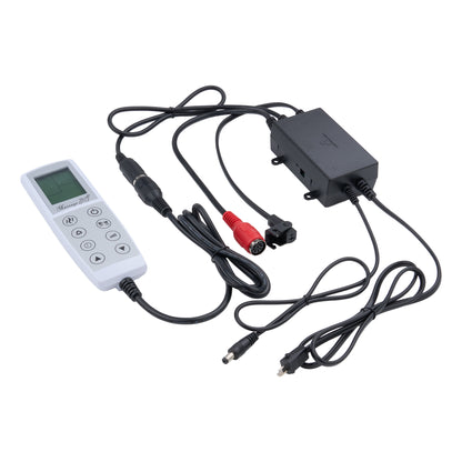 A white handheld electronic remote control with a small LCD screen and buttons, connected via black cables to a black rectangular power adapter and red connector on a white background.