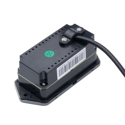 A black electronic control module with a barcode label and a green sticker, shown on a white background with a black cable attached.