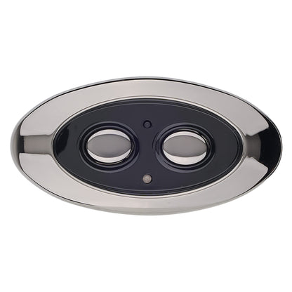 An oval wall-mounted double-sensor security camera cover with a polished chrome/silver frame and a black center containing two circular cutouts, shown on a plain white background.