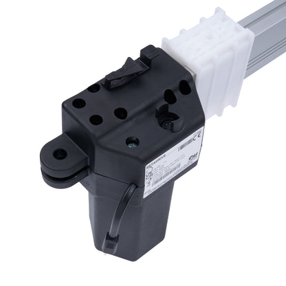 Black mechanical component with a white cable on a white background