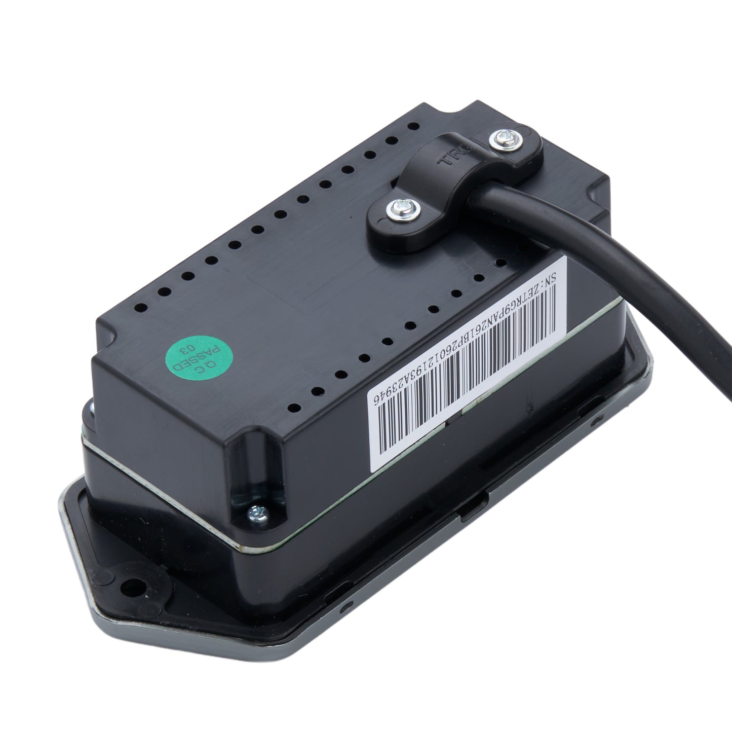 A black rectangular electronic module with a barcode label, a green circular sticker, and a black cable connected at the top, photographed on a plain white background.