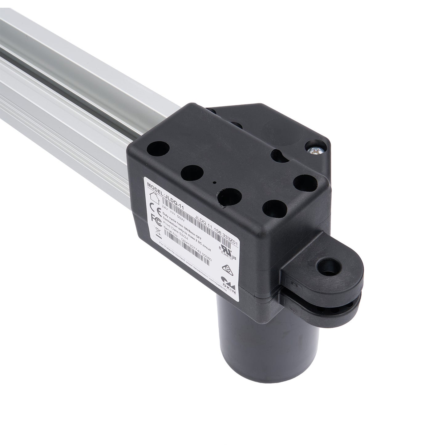 Black mechanical component with a white label on a white background