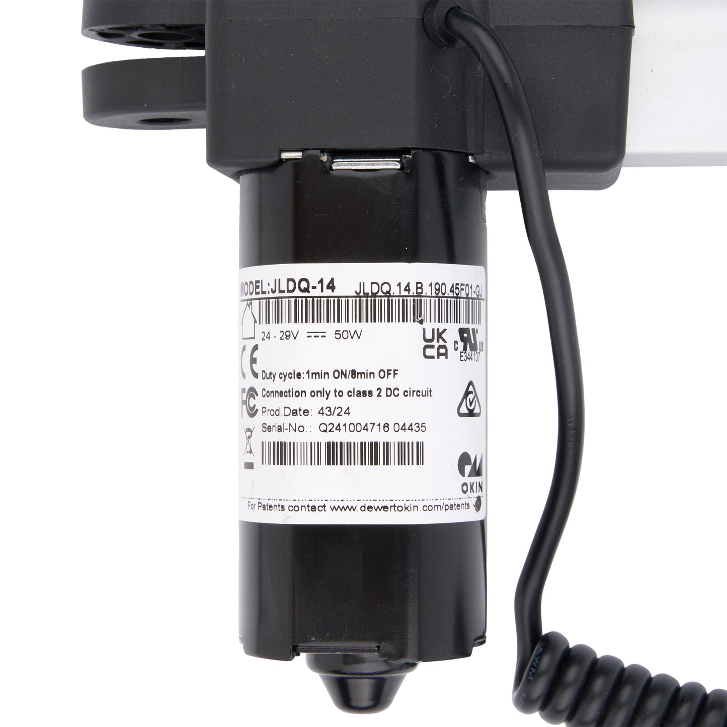 Black electrical component with coiled cable on a white background