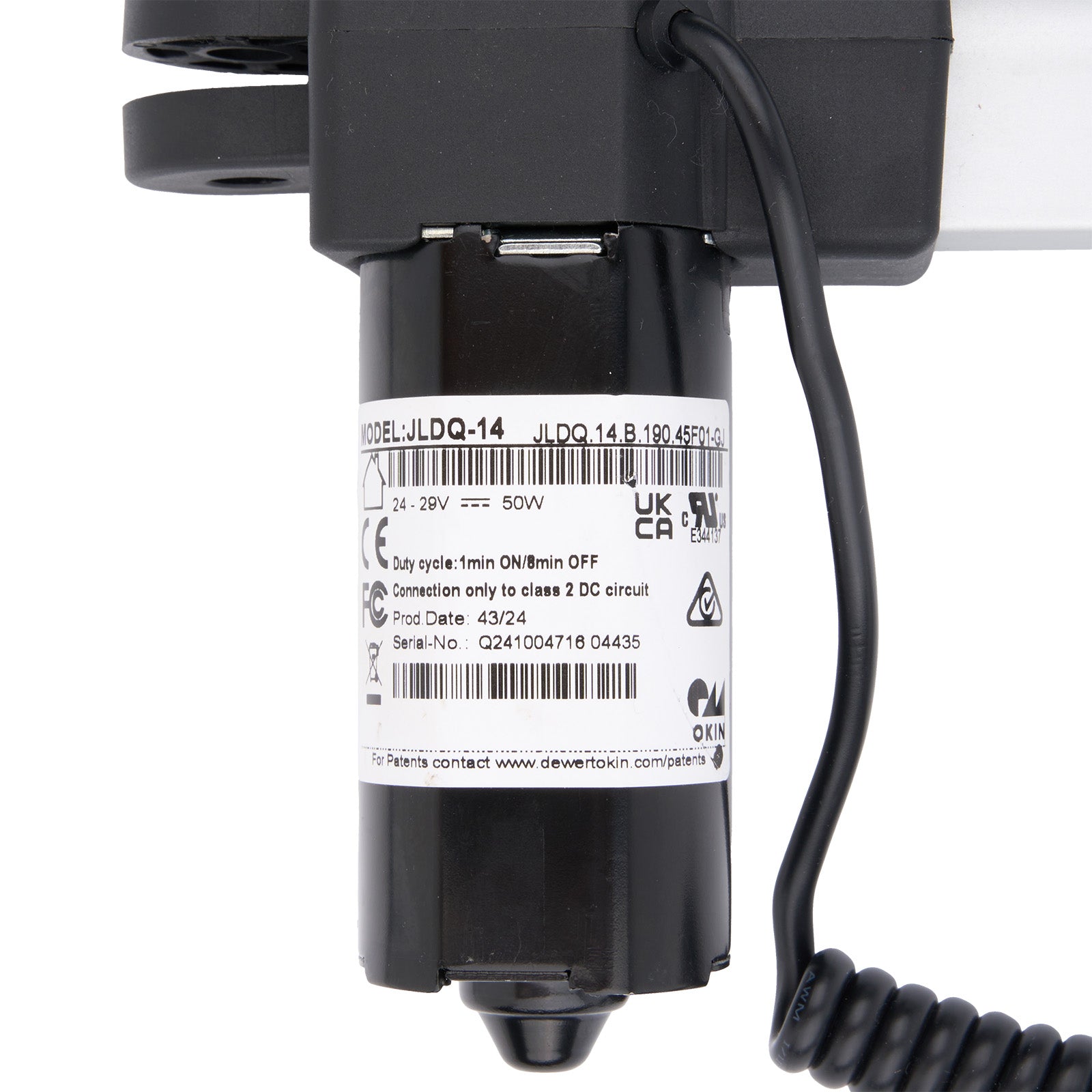 Black electrical component with coiled cable on a white background