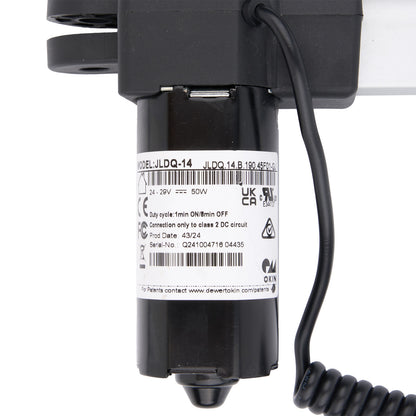 Black electrical component with coiled cable on a white background