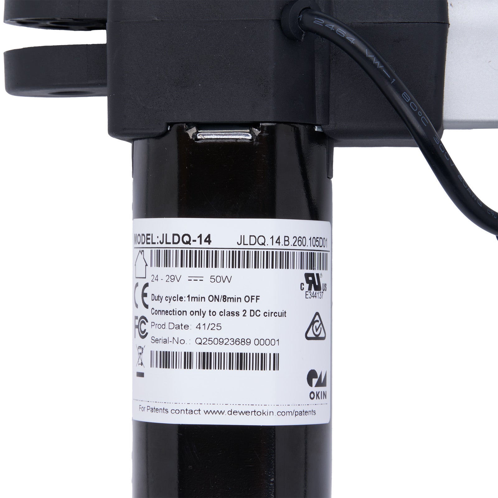 Black mechanical component with a label on a white background