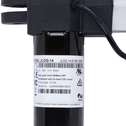 Black mechanical component with a label on a white background
