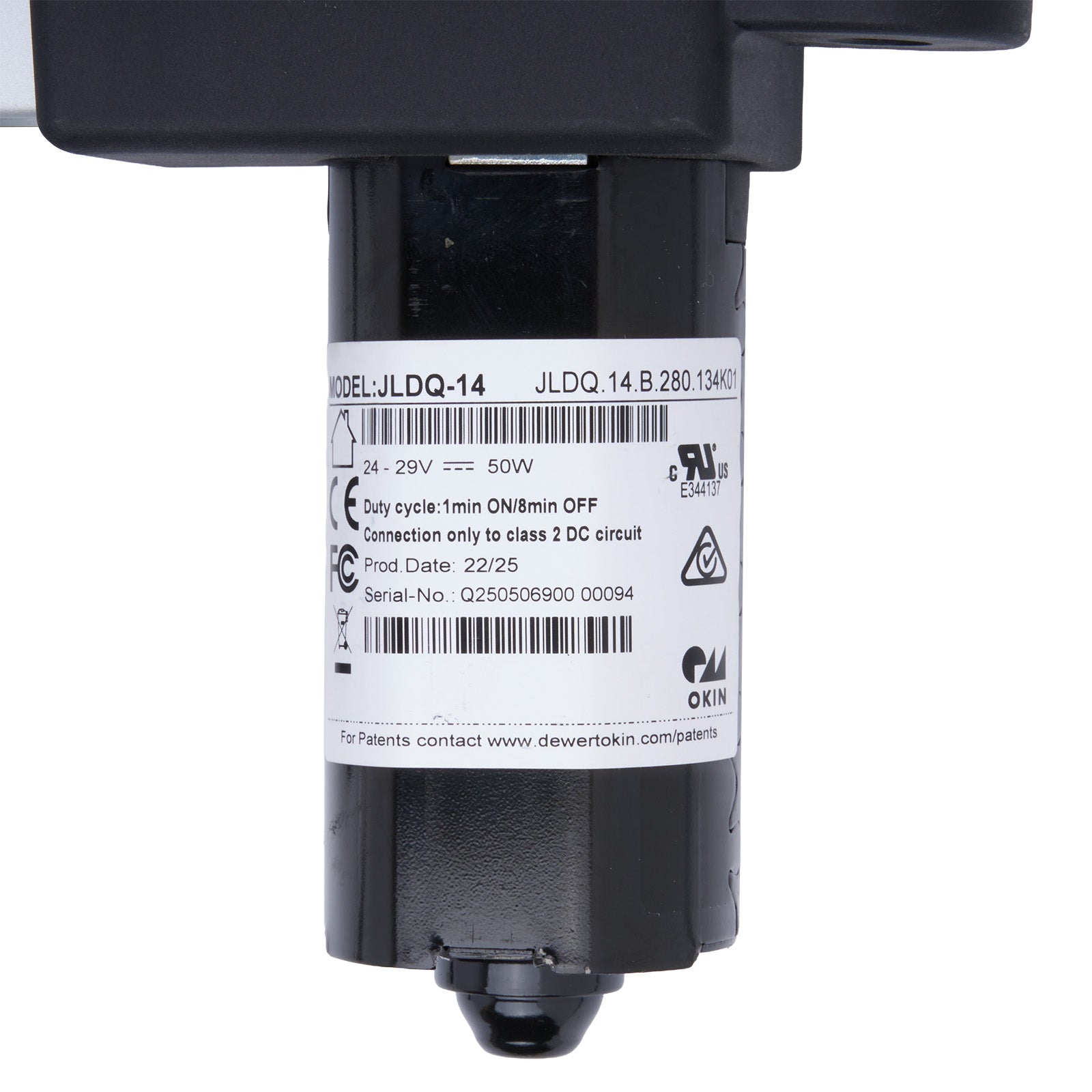 Black mechanical component with a label on a white background