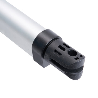 Close-up of a mechanical component with a white cylindrical part and black connector on a white background