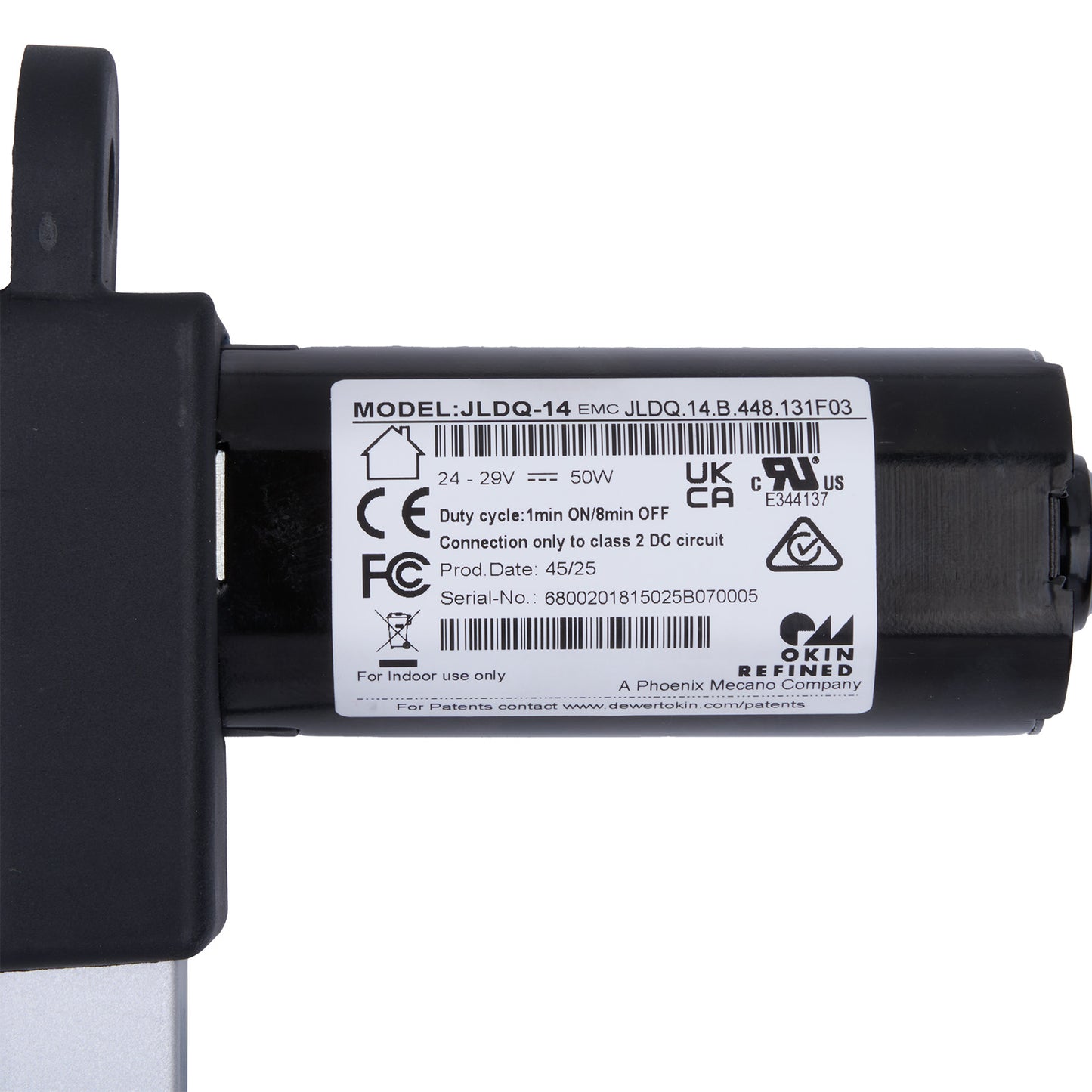 Black mechanical component with a label on a white background