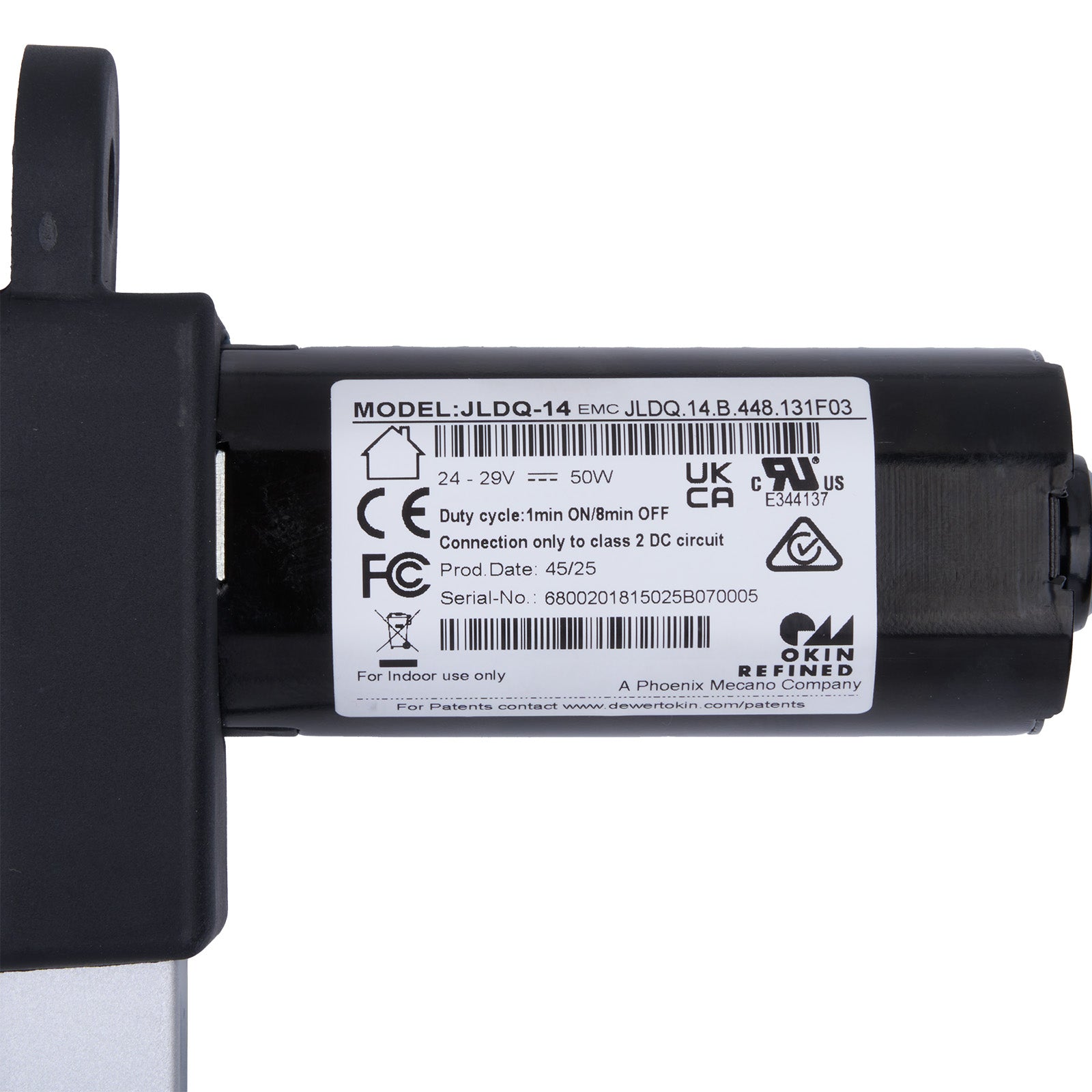 Black mechanical component with a label on a white background