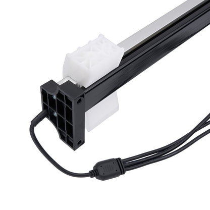 Black and white electronic component with cable on a white background