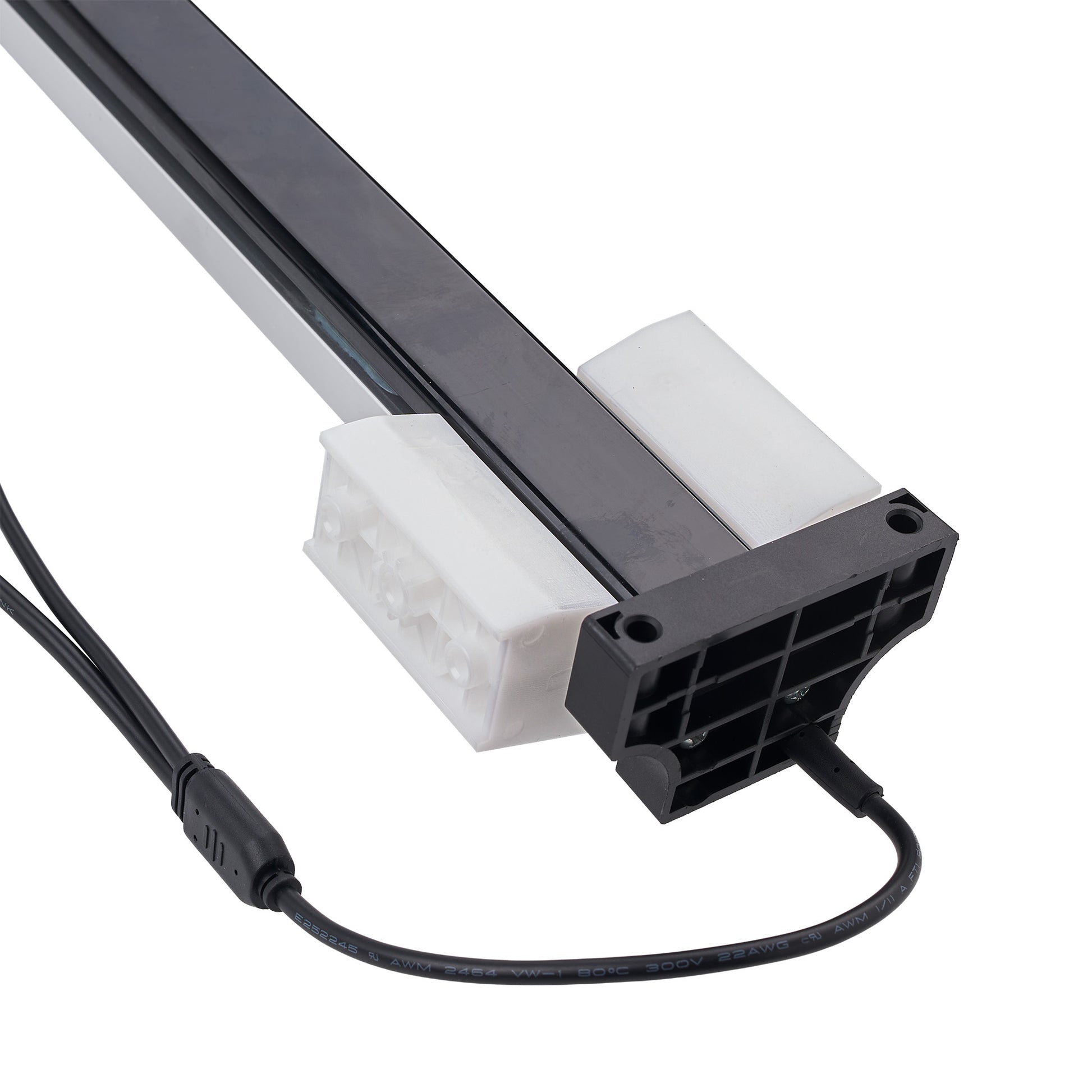 A close-up of a linear light fixture component with a black aluminum rail, white plastic mounting brackets, and a black power connector with attached cable, shown on a white background.