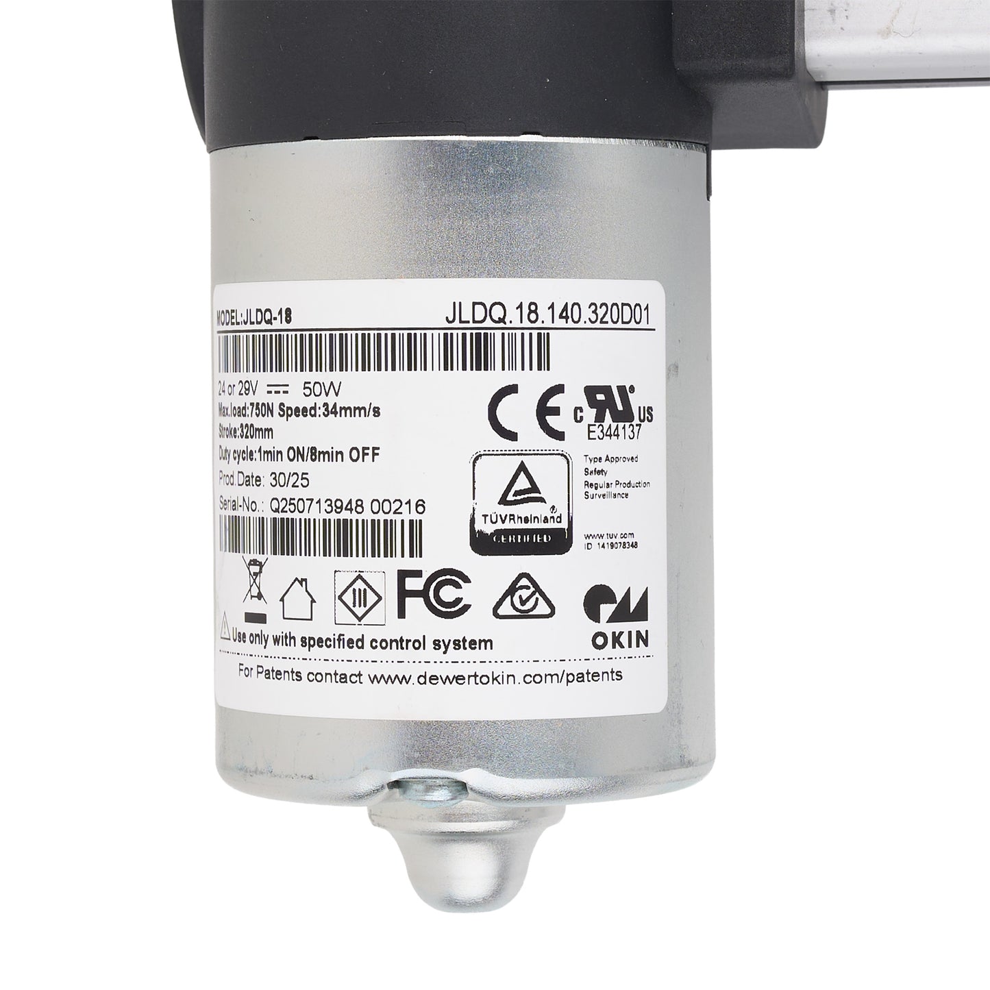 A close-up of a silver cylindrical industrial motor or pump component with a black top section, a white product label showing barcodes and certification marks, and a small metal fitting at the bottom, photographed on a white background.