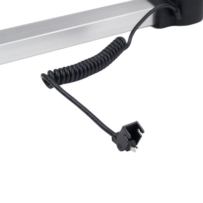 Black coiled cable with a plug on a white background