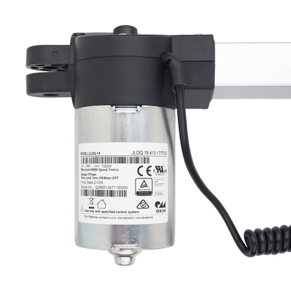 A silver and black electric linear motor drive with a coiled black cable, shown on a clean white background.