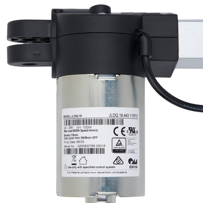 Close-up of a black and silver mechanical device with visible branding and certification labels on a white background.