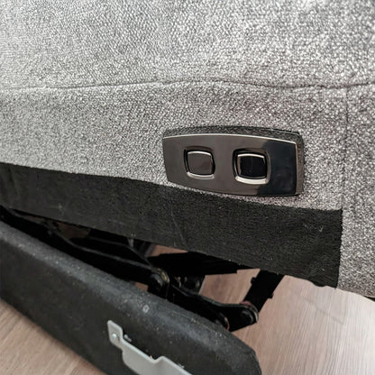 Close-up of a car's tailgate with a silver emblem on a textured surface.