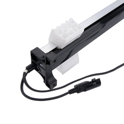 Black and white mechanical component with a cable on a white background