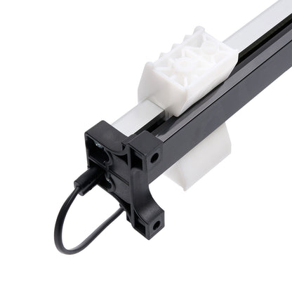 Close-up of a mechanical component with a white gear and black and gray metal parts on a white background.