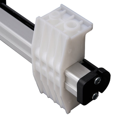 Close-up of a mechanical component with white plastic housing and black metal parts on a white background