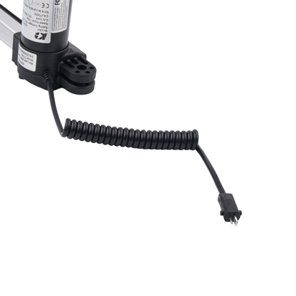 A close-up of a black coiled cable connected to a cylindrical black and white motor or sensor component on a plain white background.