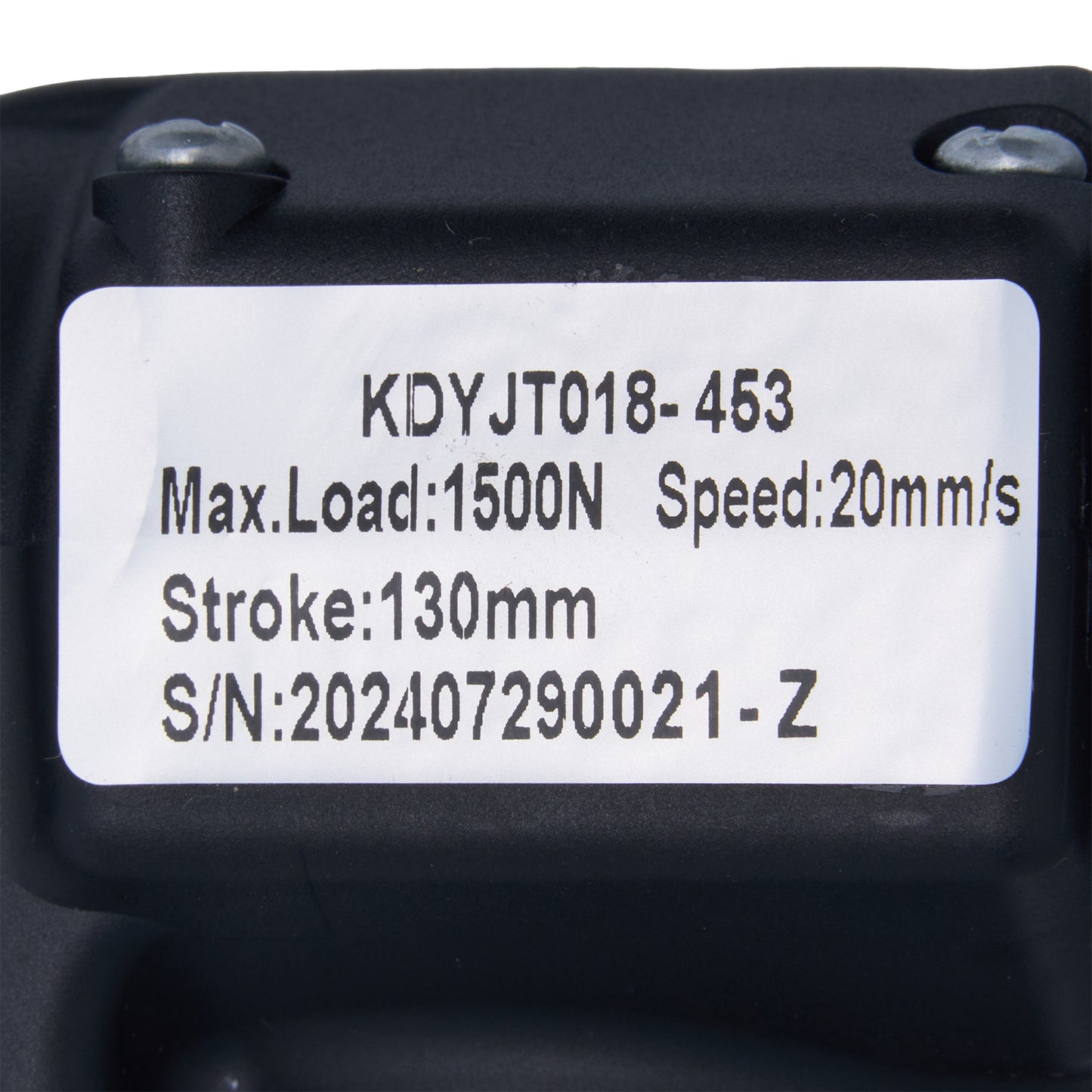 Black mechanical component with technical specifications label on a white background