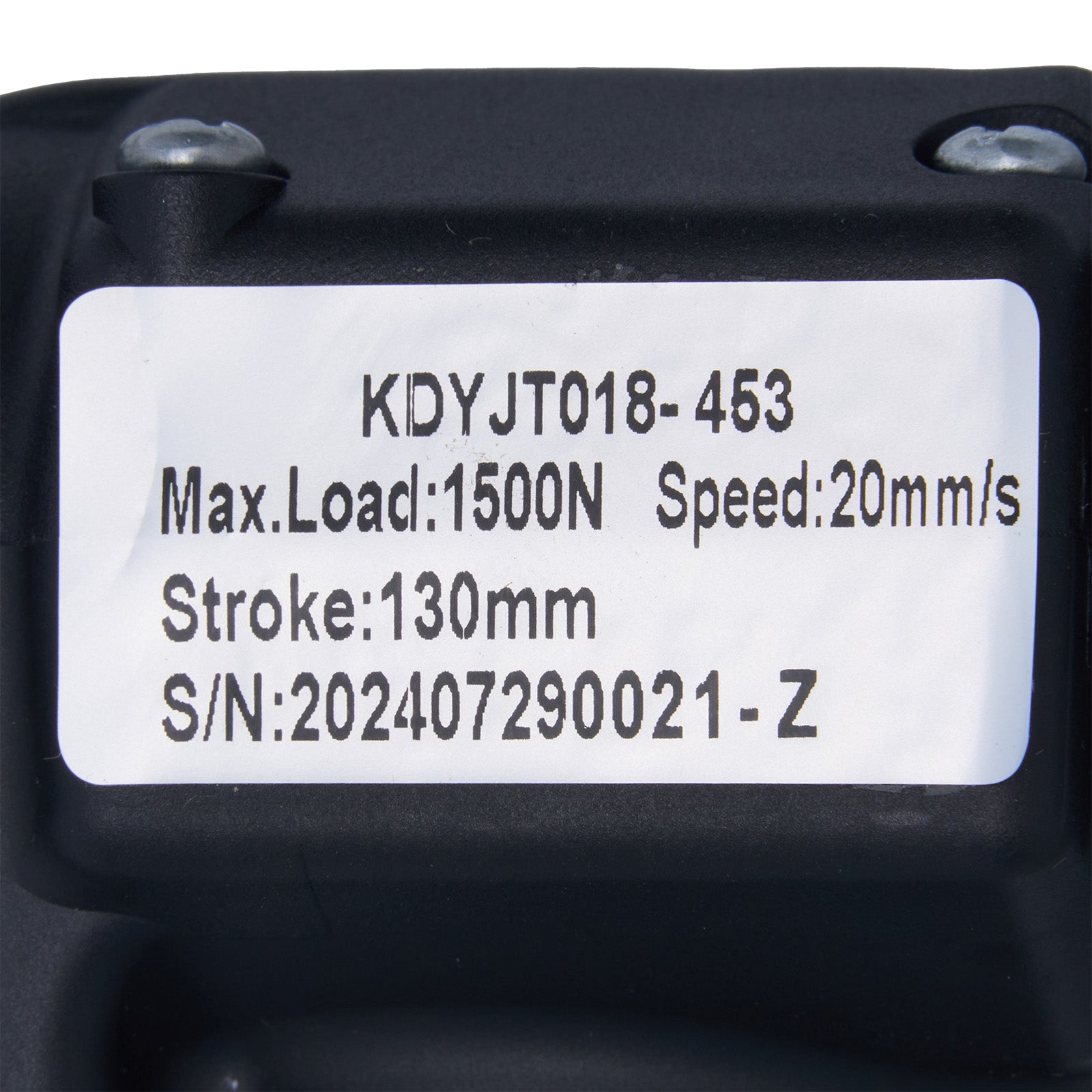 Black mechanical component with technical specifications label on a white background