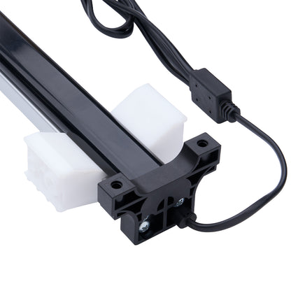 Black mechanical component with a white block and black cable on a white background