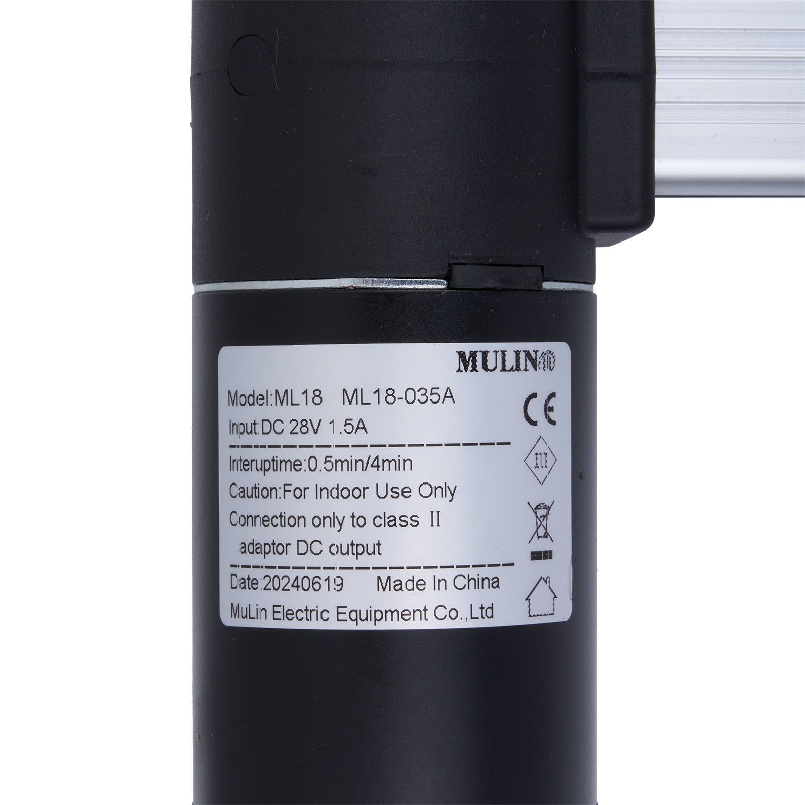 Black cylindrical device with a label on a white background