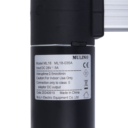 Black cylindrical device with a label on a white background