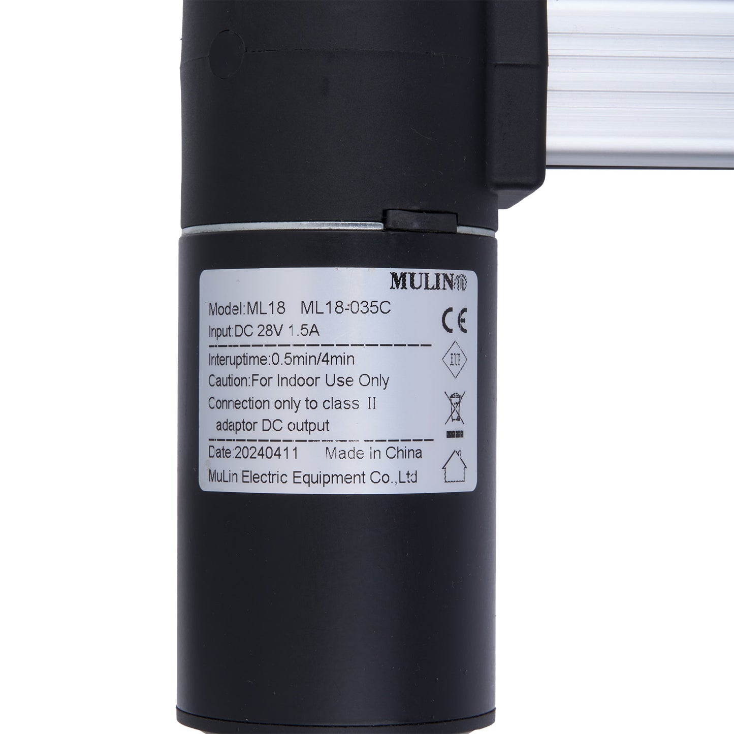Black cylindrical device with a label on a white background