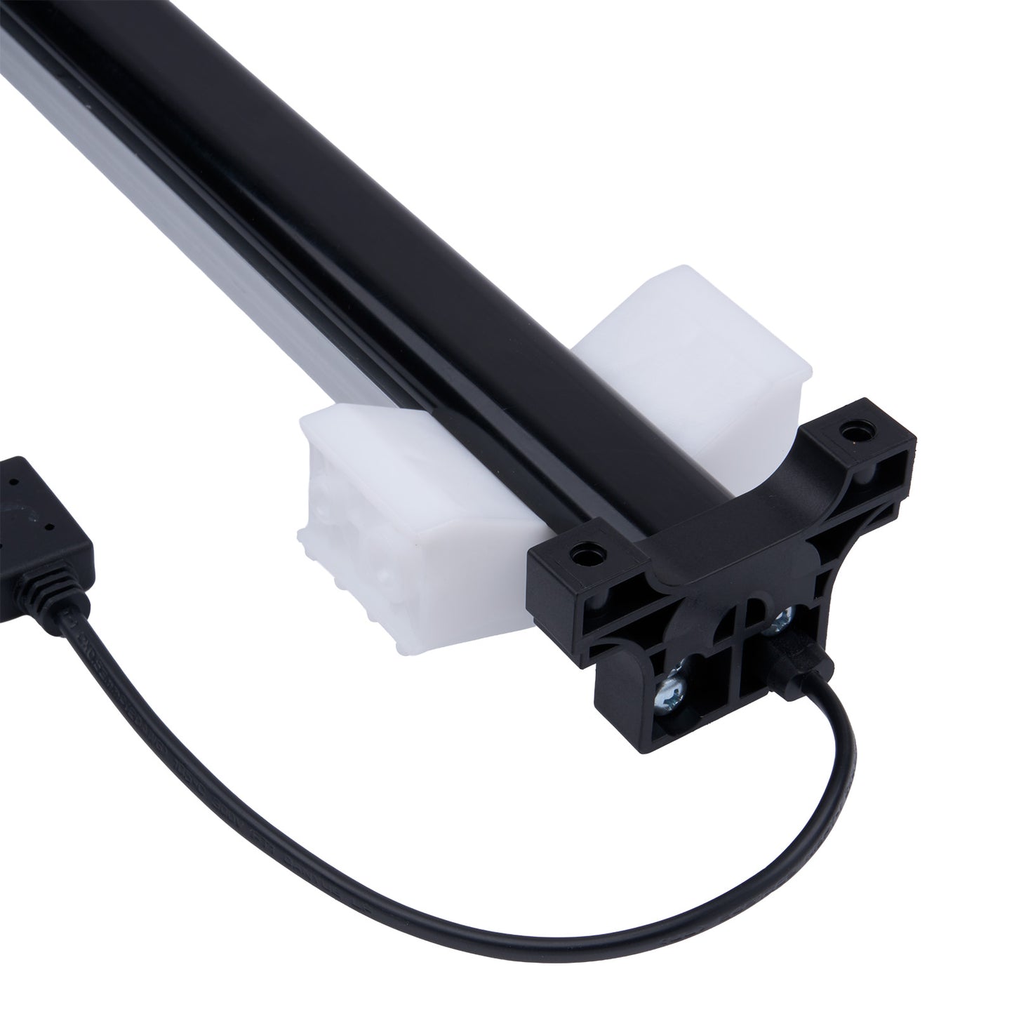 Black mechanical component with white plastic parts on a white background