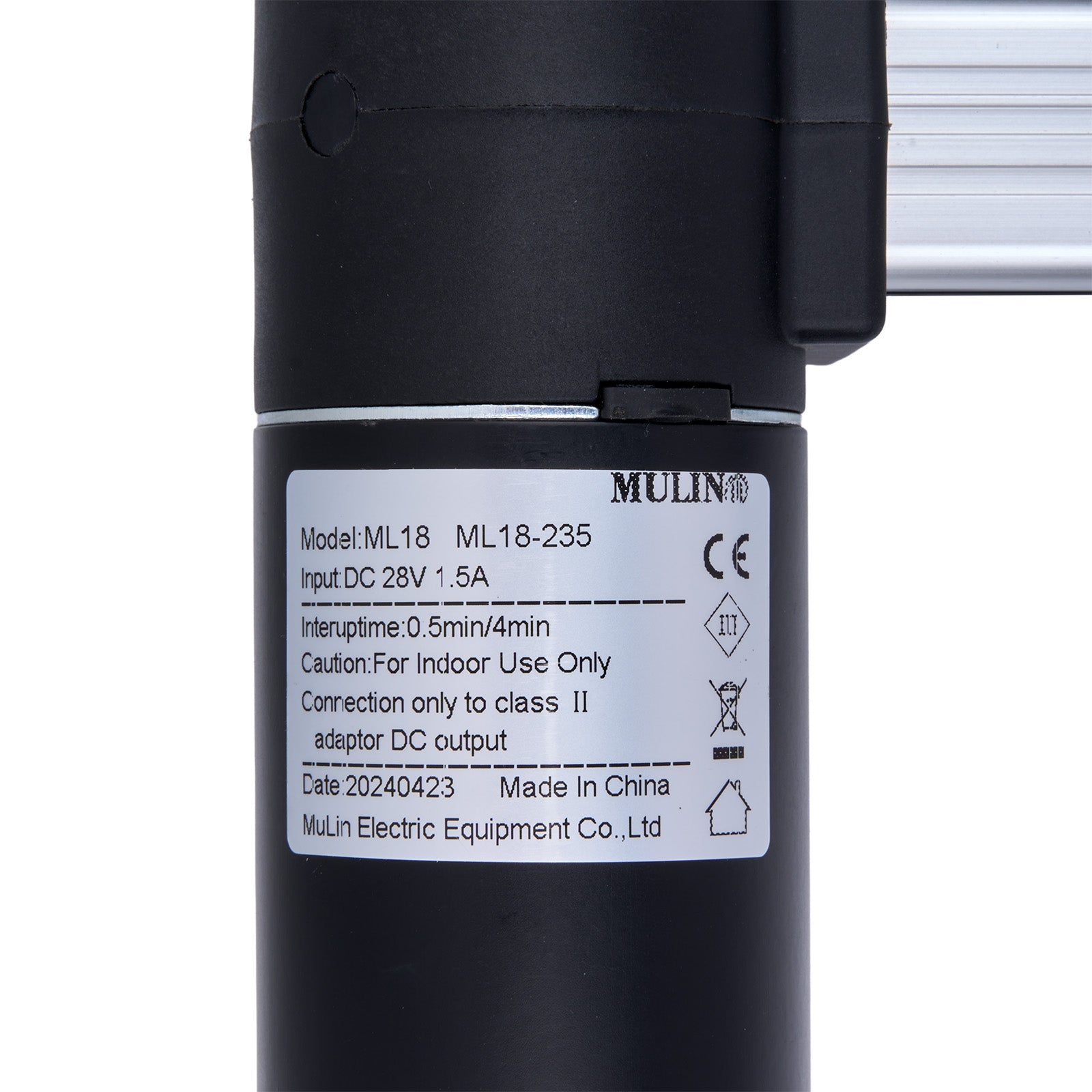 Black cylindrical device with a label on a white background