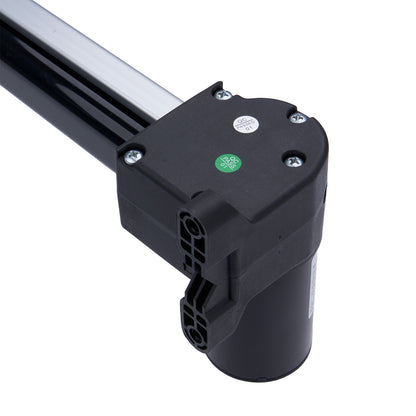 Black mechanical component with a green label on a white background