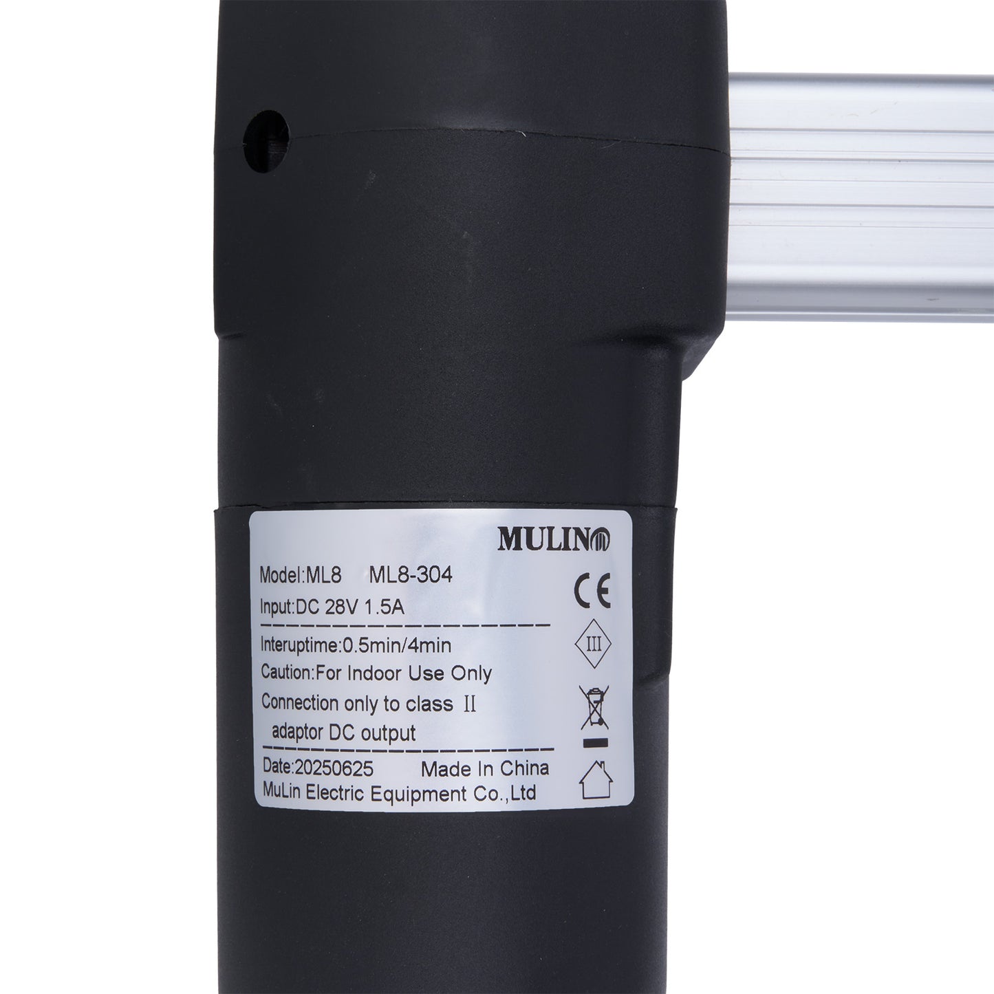 Black cylindrical device with a label on a white background