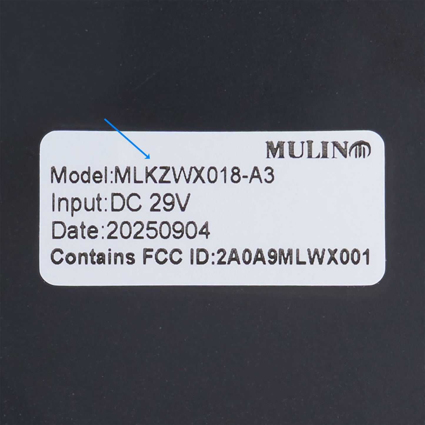 Product label with model number, input voltage, date code, and FCC ID on a dark background