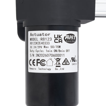 A close-up of a black cylindrical electric actuator with a white product specification label showing the model UKCA R8123 and brand ATI.