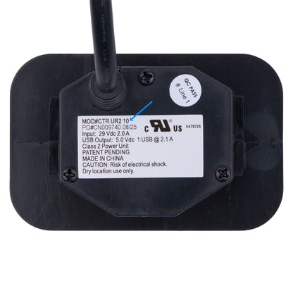 The back of a black USB power adapter with a single antenna, showing a white label with technical specifications, a UL US certification mark, and a white circular sticker.