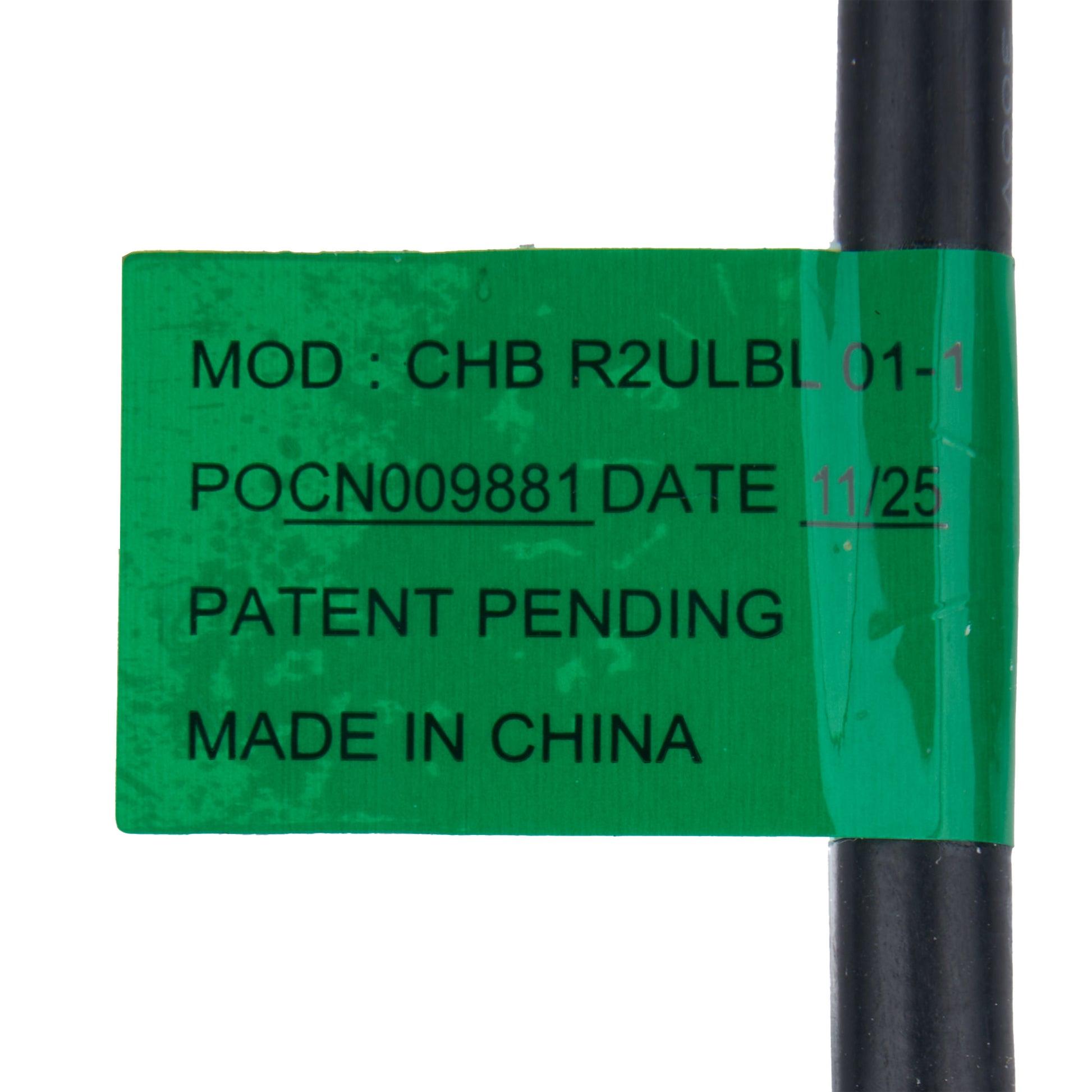 Green label with text on a black cylindrical object