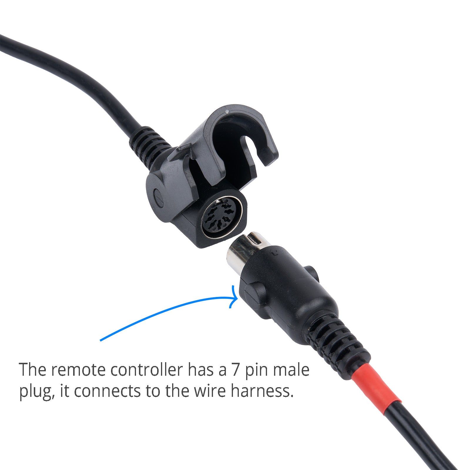 Close-up of a remote controller with a 7 pin male plug connector on a white background.