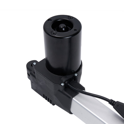 Black cylindrical component attached to a metallic arm with a white background.