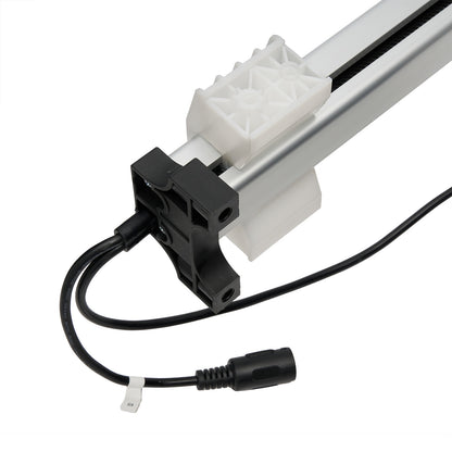 Close-up of a mechanical component with a white gear and black wiring on a white background.