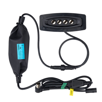 RG00200273  Black electronic device with cables on a white background