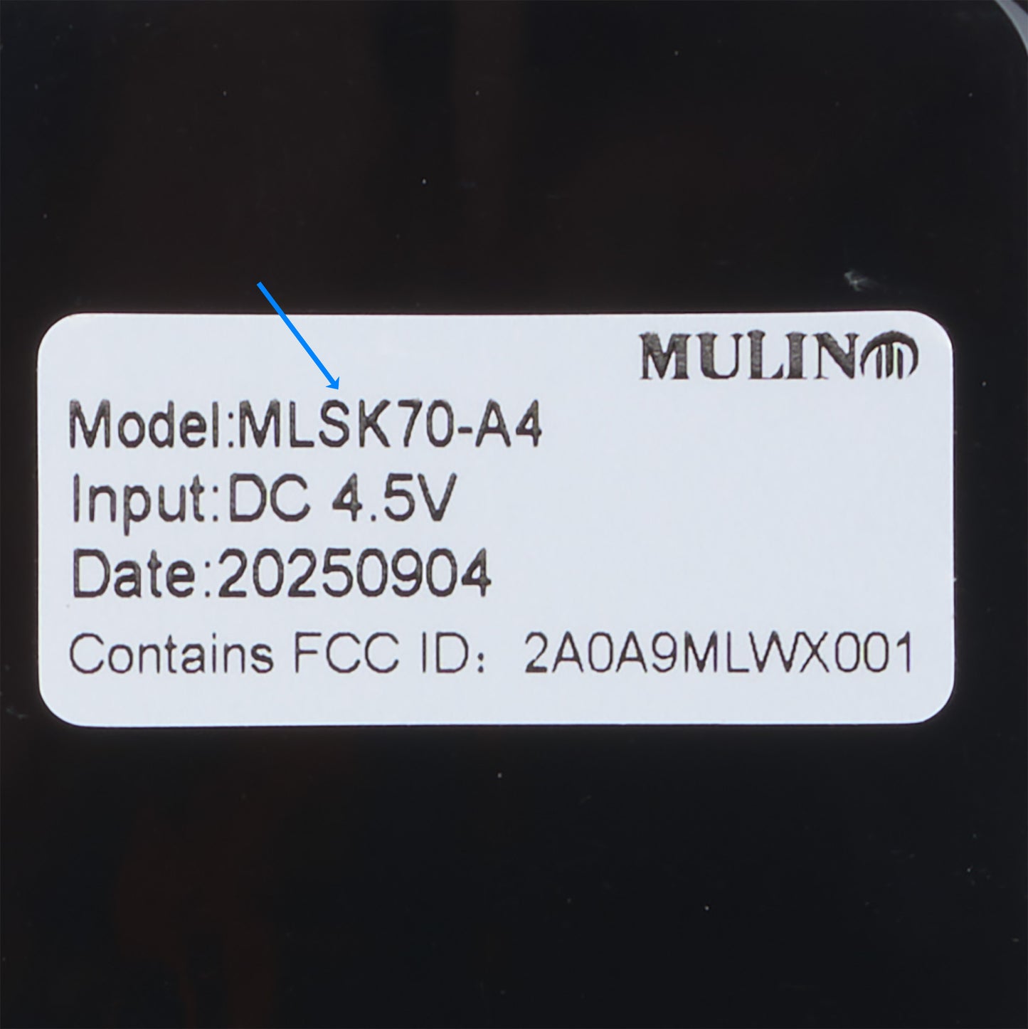 Product label with model number, input voltage, date code, and FCC ID on a black background